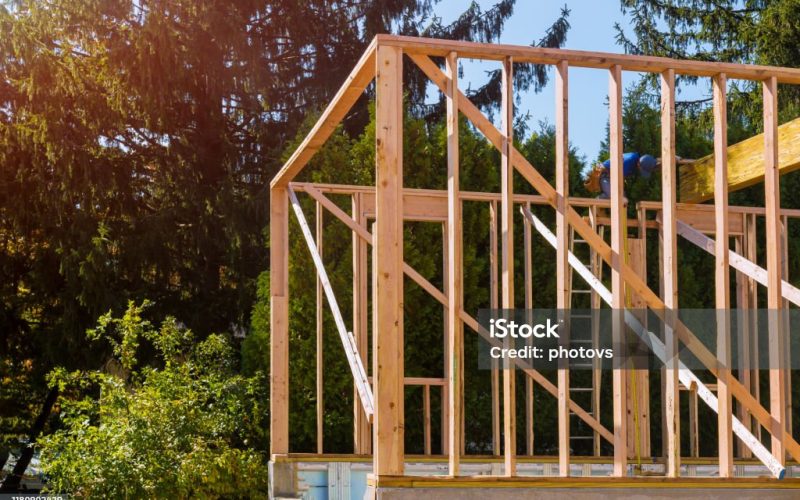 Beam stick built frame of a new house under construction of the wooden house
